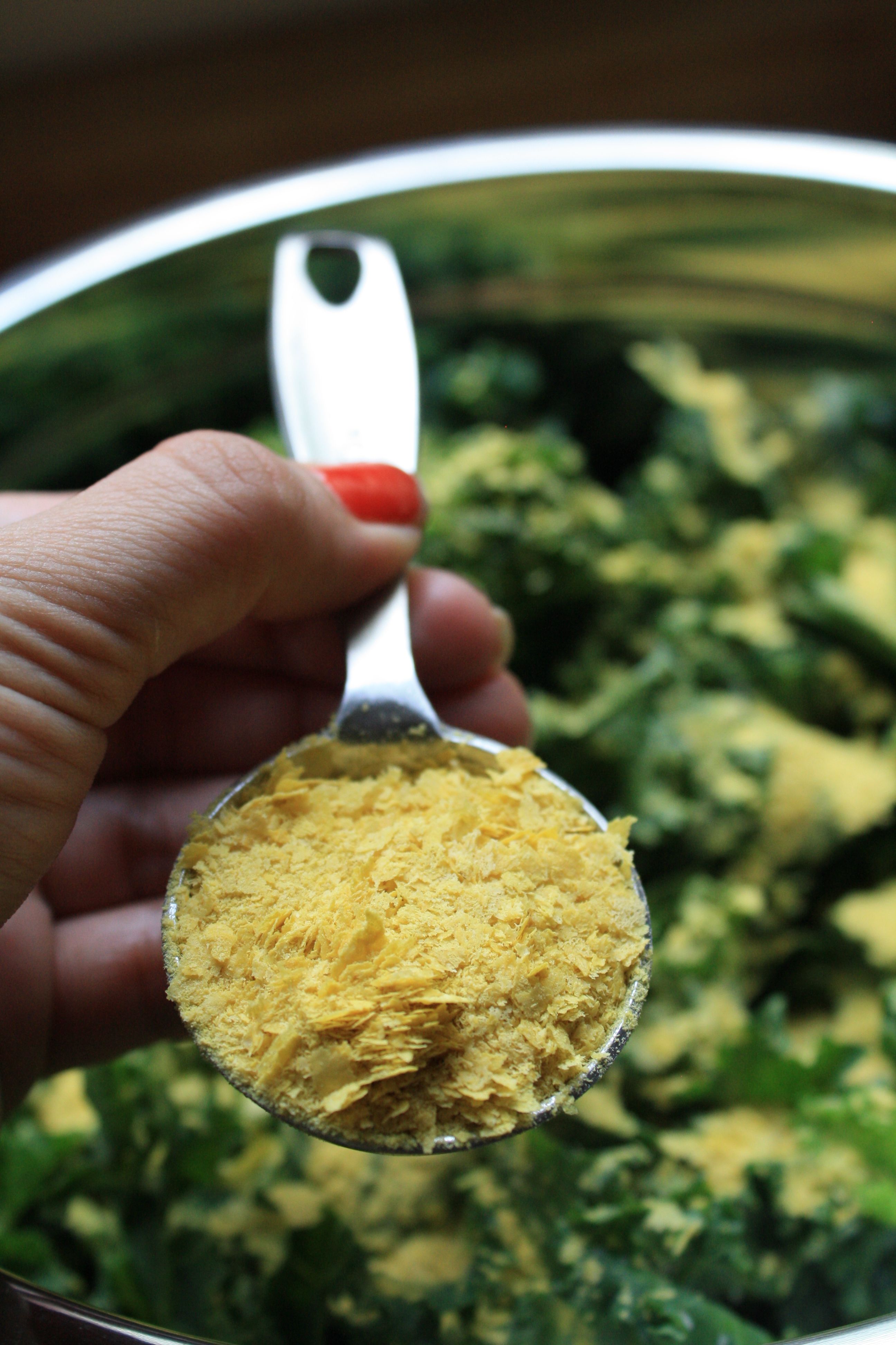 add 4 tablespoons nutritional yeast to kale leaves
