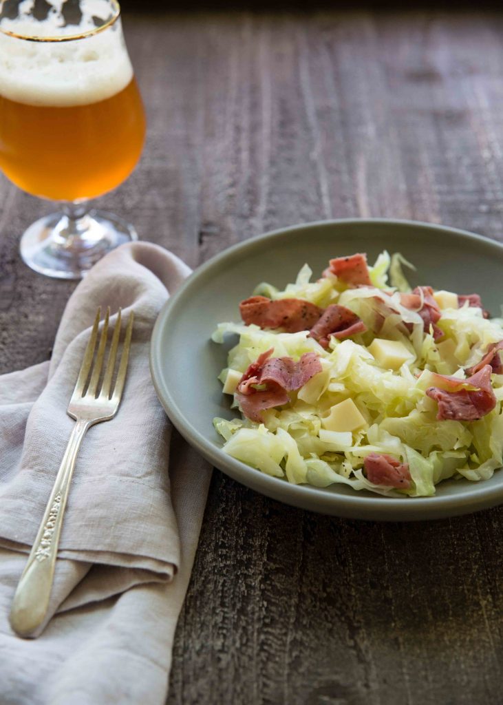 As the outdoors get chilly during autumn, serve warm salads. We love this Warm IPA Braised Cabbage Salad with Pastrami and Swiss cheese.