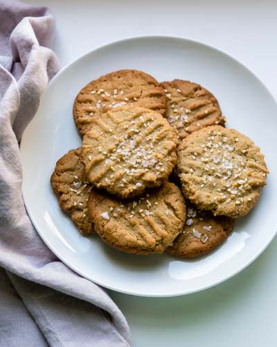 Tahini butter cookies are a riff on nutty peanut butter cookies with a flourish of sea salt and sesame seeds on top.